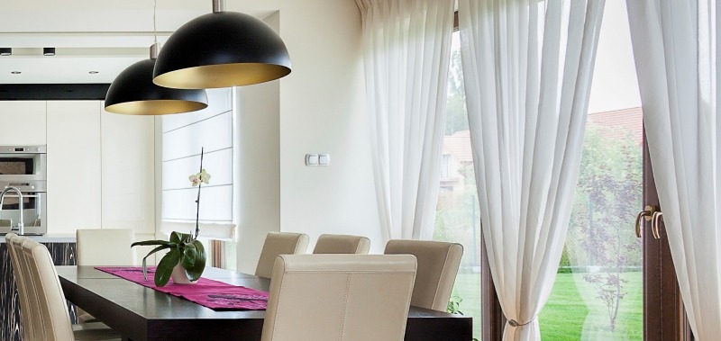 Drapes are a great choice for glass windows. 